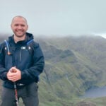 Image of Alfie Golden with a cliff in the background